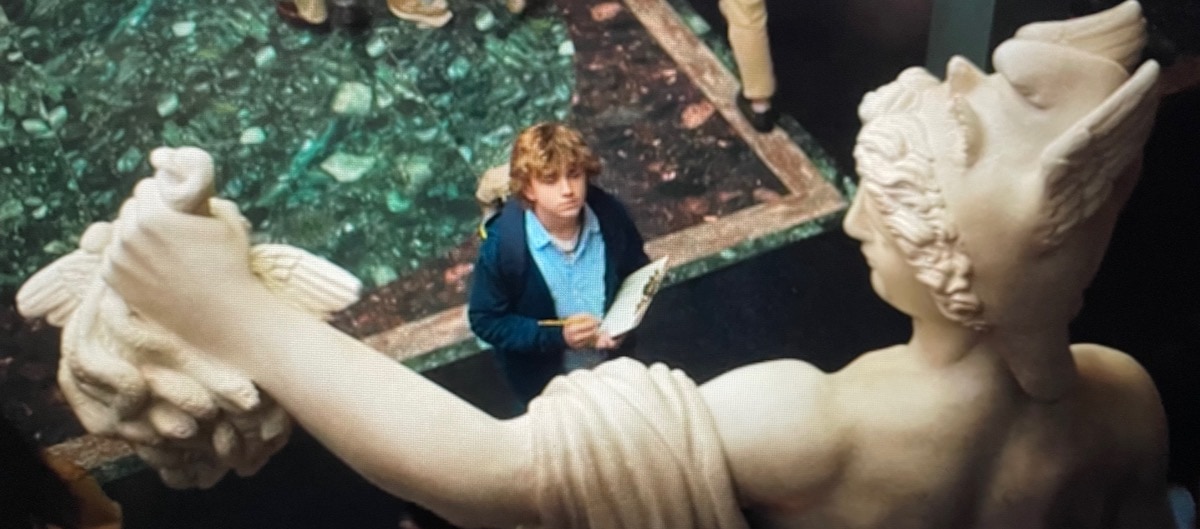 Percy Jackson in museum with statue of Greek Hero Perseus