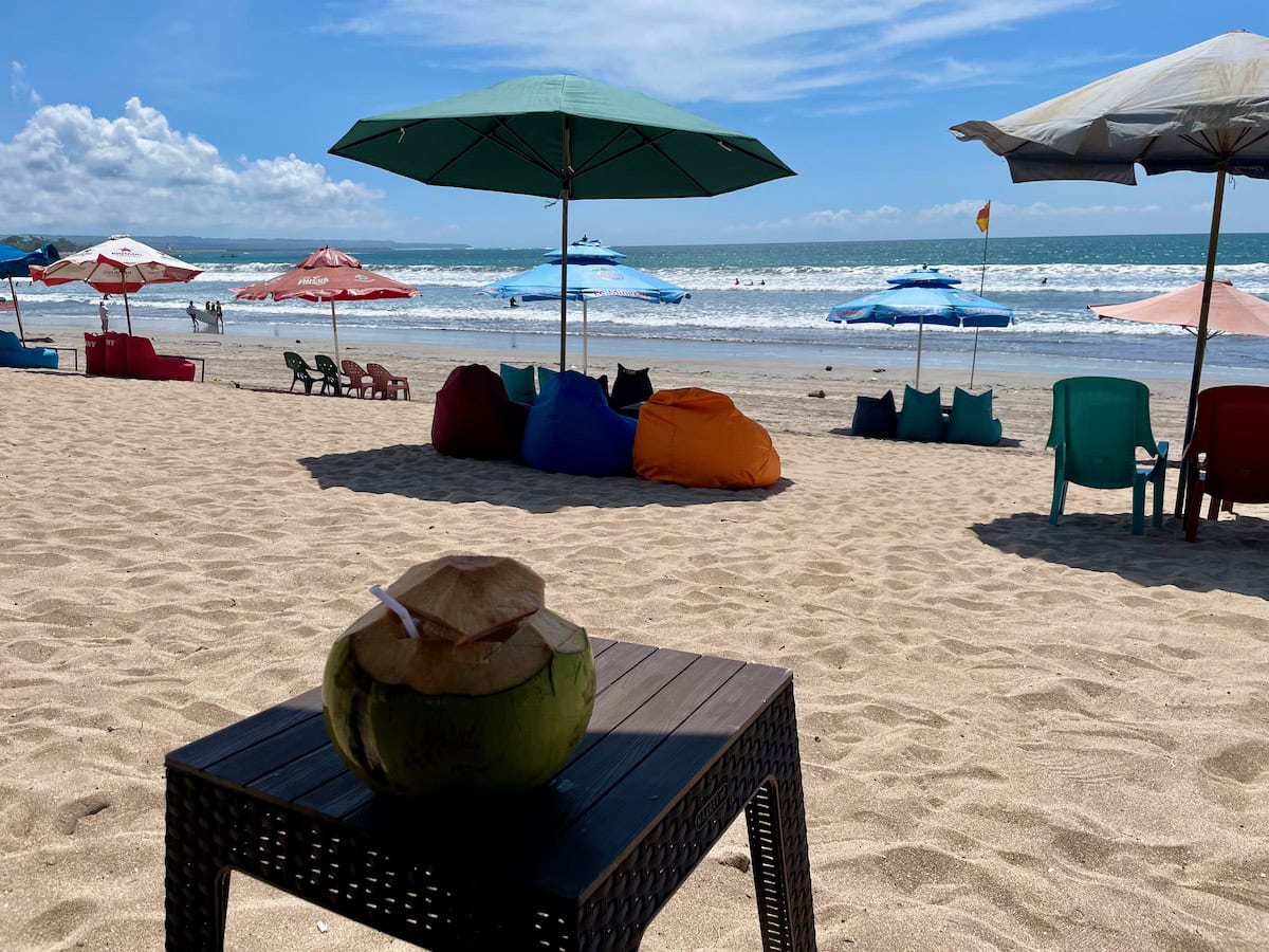 Relaxing at Kuta Beach with a Coconut Drink