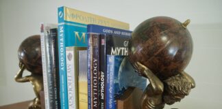 Row of Books about Greek Mythology and Gods held together by Atlas Titan Bookends