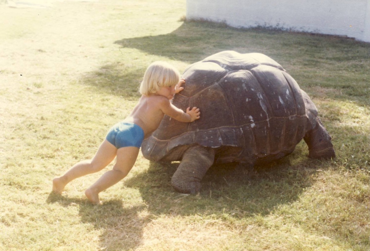Young Laurence Norah in Seychelles with Giant Tortoise