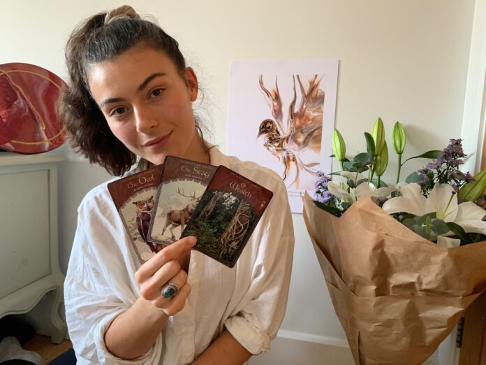 Jaimilee holding Oracle Tarot Cards